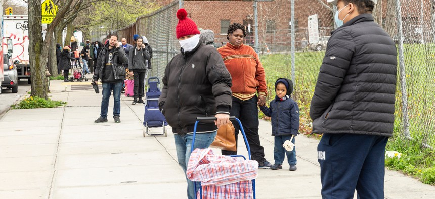 New Yorkers wait in line to get food at a food pantry in Brooklyn in April 2020.