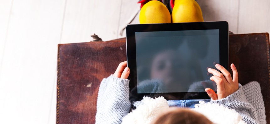 Child looking at tablet.