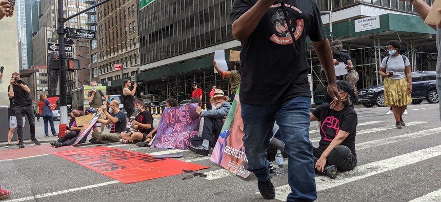 Protesters lined up on Broadway with signs criticizing Mayor Bill de Blasio and his treatment of homeless New Yorkers.