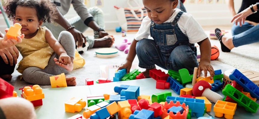 Toddlers playing with toys.