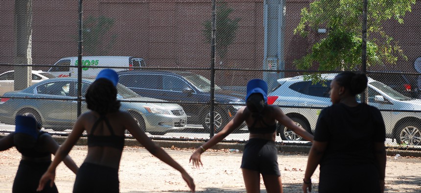 Youth practicing marching band outside.