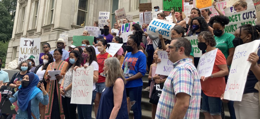 A rally against the DOE cuts on the steps of City Hall on July 18.