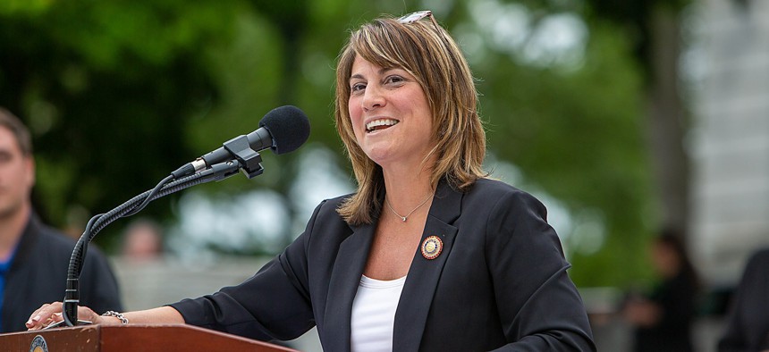 State Rep. Carrie Lewis DelRosso speaks at a podium