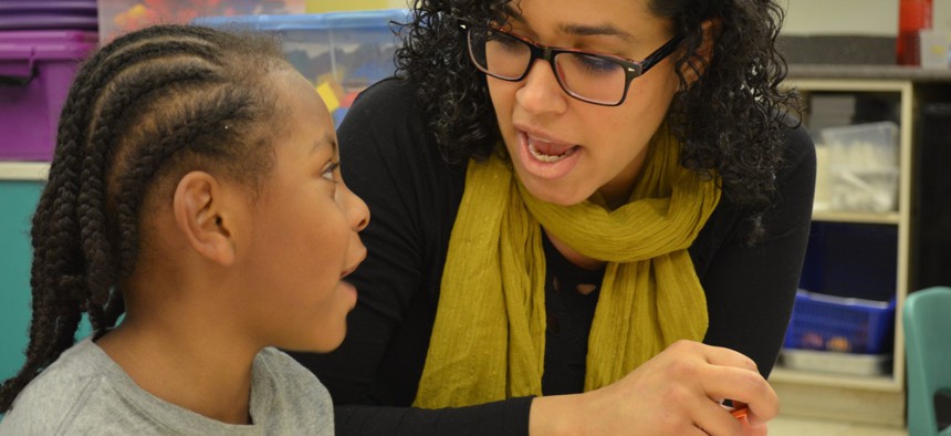  Young male child observes teacher. 