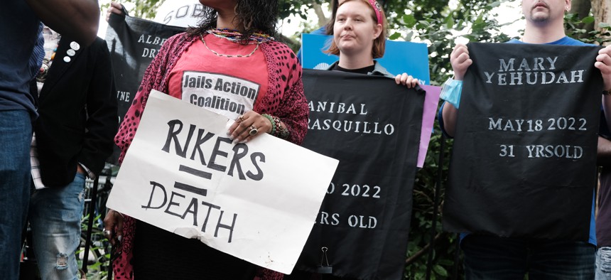 Family members, activists and others hold a rally outside of City Hall in June to demand action over the humanitarian crisis at Rikers Island. 