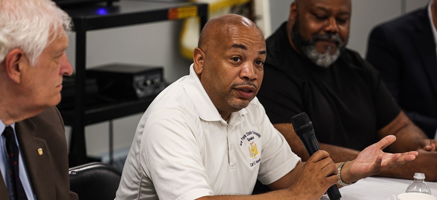 Gordon Heights, N.Y.: Assembly Speaker Carl E. Heastie (D-Bronx), center, Assemblyman Steve Englebright, left, and E. James Freeman, the President of the Gordon Heights Civic Association, right, speaks at a community meeting to discuss environmental issues and redistricting, at the Gordon Heights firehouse, in Gordon Heights, New York, on June 20,2022.