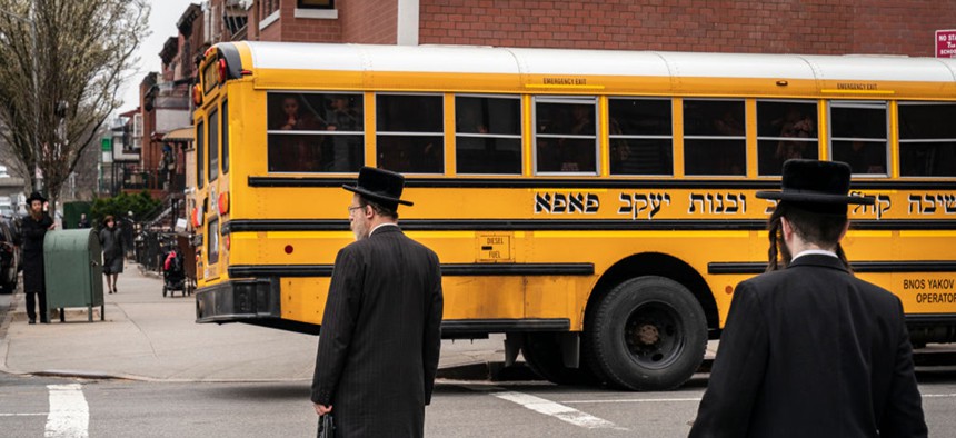 NEW YORK, NY - APRIL 9: Pedestrians walk near the Yeshiva Kehilath Yakov School in the South Williamsburg neighborhood, April 9, 2019 in the Brooklyn borough of New York City.