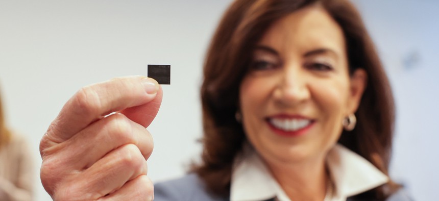 Gov. Kathy Hochul holds a semiconductor chip at an announcement Tuesday that semiconductor company Micron was building a $100 billion manufacturing facility near Syracuse. 