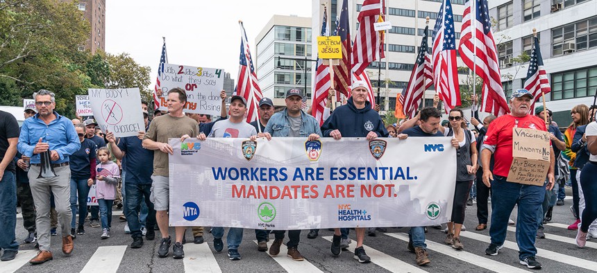 Municipal workers marched across the Brooklyn Bridge to protest vaccine mandates on Oct. 25, 2021.
