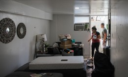 Two residents of a basement apartment in Queens attempt to clean up after flooding from remnants of Hurricane Ida in 2021.