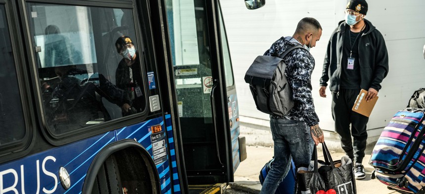 Migrants formerly housed at a Midtown Manhattan hotel arrive by bus at their new home in the Brooklyn Cruise Terminal in Red Hook.