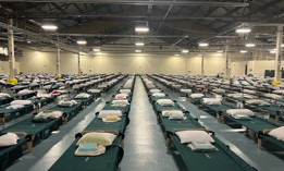 Cots are crowded up against each other in the Brooklyn Cruise Terminal being used to house migrants.
