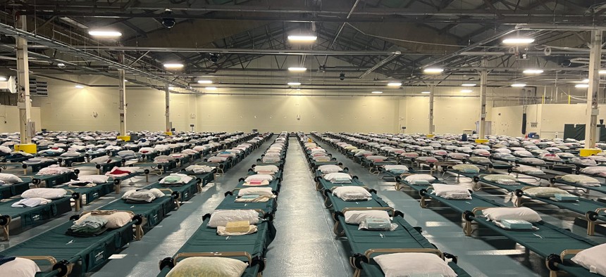 Cots are crowded up against each other in the Brooklyn Cruise Terminal being used to house migrants.