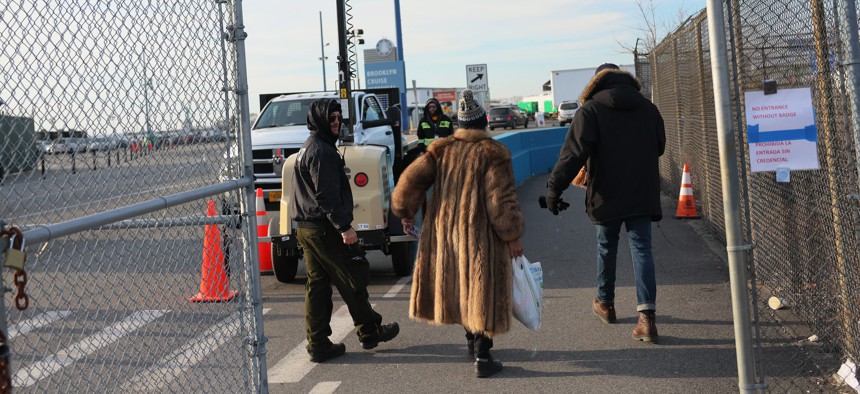 People enter the migrant relief center at Brooklyn Cruise Terminal