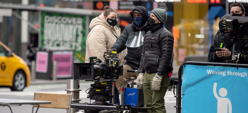 A camera crew waits on a film set in Times Square.