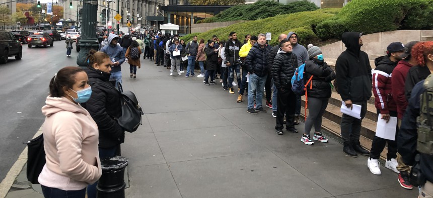 Migrants waiting in line to enter 26 Federal Plaza in lower Manhattan
