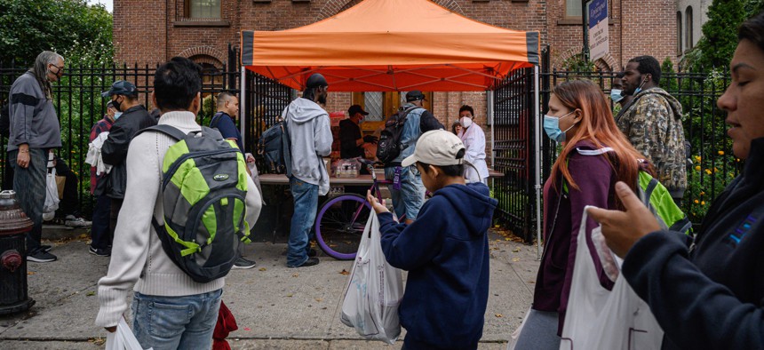 People line up for hot food at the Holy Apostles Soup Kitchen food pantry in Manhattan. 