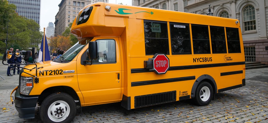 A zero-emissions bus parked in front of City Hall