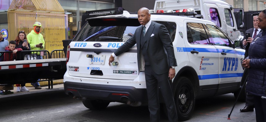 Mayor Eric Adams points to a GPS tracker projectile attached to an NYPD vehicle, during a demonstration of new NYPD surveillance technologies.