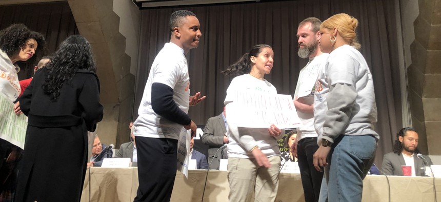 Protesters, including from left City Council Members Sandy Nurse, Shahana Hanif, Chi Ossé and Tiffany Cabán, circled the board as they attempted to hold their meeting. 