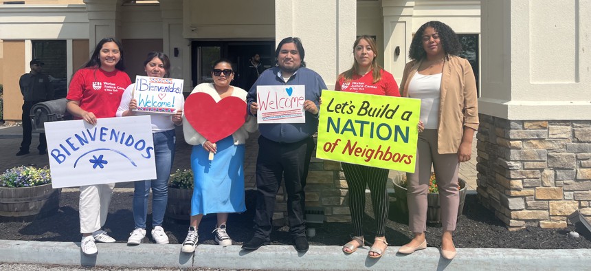 Rene Mejia Jr (third from right) and other advocates prepare wait outside the Crossroads Hotel to welcome asylum seekers in Newburgh, NY.