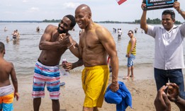 Eric Adams poses for a photo with beachgoers at Orchard Beach in the Bronx, while campaigning for mayor on June 19, 2021.