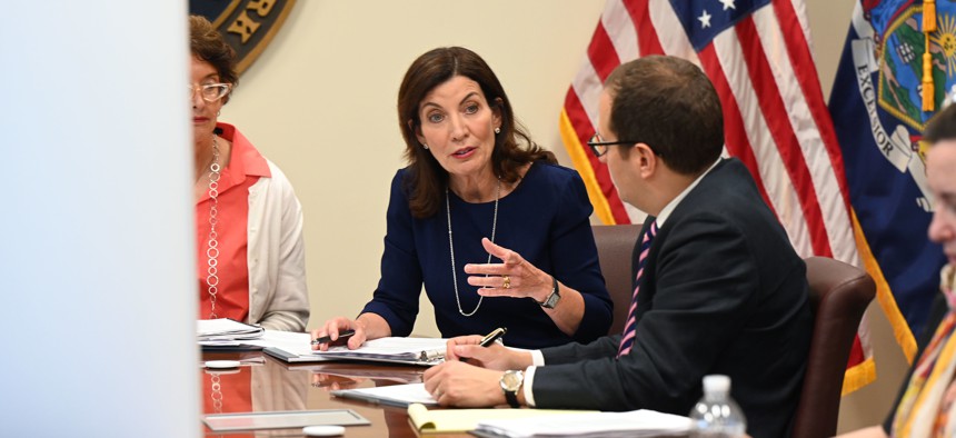 Counsel to the Governor Elizabeth Fine, left, Gov. Kathy Hochul, center, and Director of Policy Micah Lasher