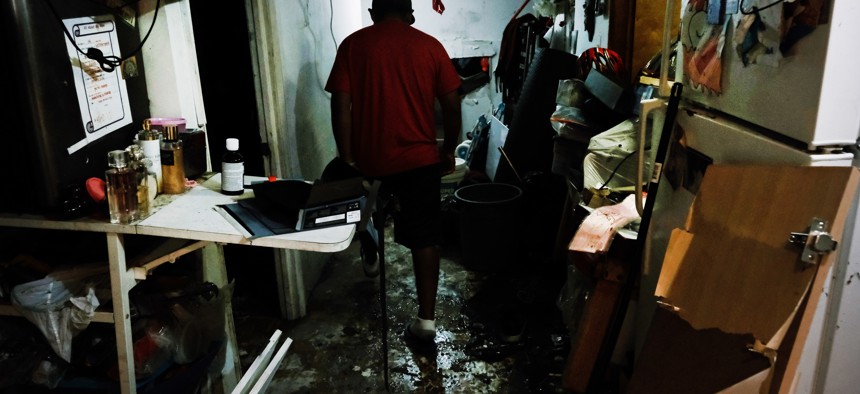  Eddie, an immigrant from Mexico, walks through his flooded basement level apartment in a Queens neighborhood that saw massive flooding and numerous deaths following a night of heavy wind and rain from the remnants of Hurricane Ida on September 03, 2021 in New York City.