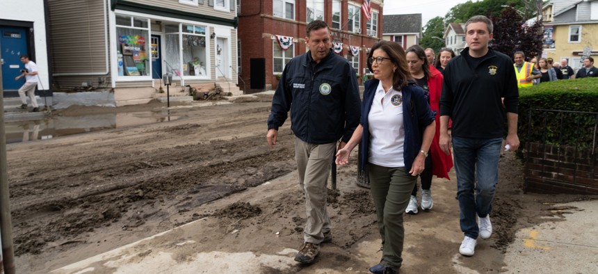 From left: Orange County Executive Steve Neuhaus, Gov. Kathy Hochul and state Sen. James Skoufis tour the storm damage in Highland Falls.