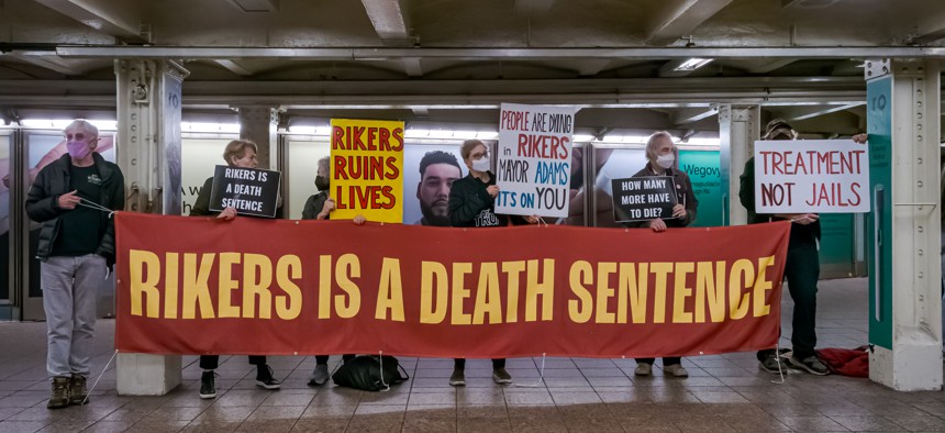 Members of the activist group Rise and Resist hold a banner in the Times Square subway station during the Close Rikers Vigil on April 3, 2023.