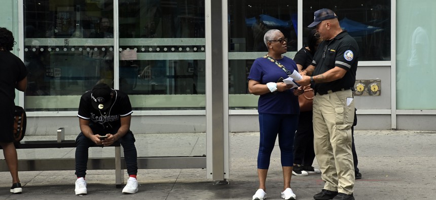 A member of the Metropolitan Transportation Authority’s Evasion and Graffiti Lawlessness Eradication team speaks to a bus rider at a stop in Downtown Brooklyn.