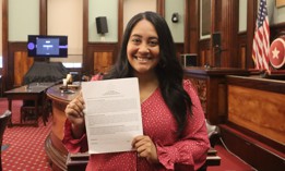 Council Member Amanda Farías holds up the sign-on letter for the Menstrual Equity bills package.