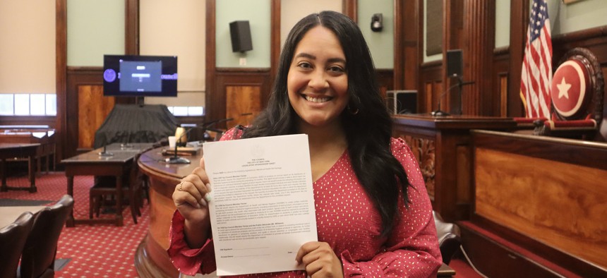 Council Member Amanda Farías holds up the sign-on letter for the Menstrual Equity bills package.