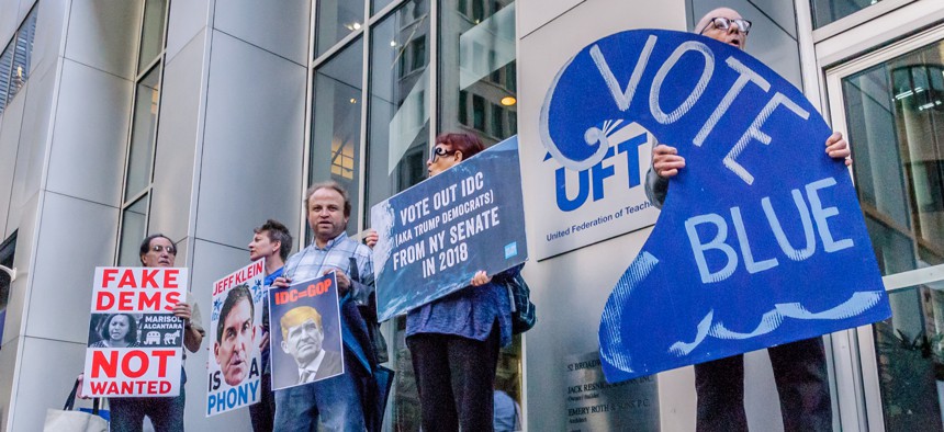 Protesters urge the UFT teachers union to support primary challengers of IDC members in 2018.