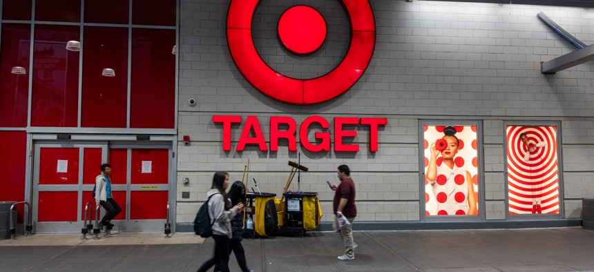 People walk by a Target store in East Harlem that is expected to close soon due to retail theft, according to the company.