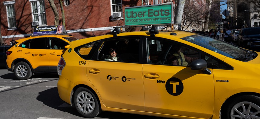 A woman looks out from a yellow cab near Washington Square Park on March 26, 2023.