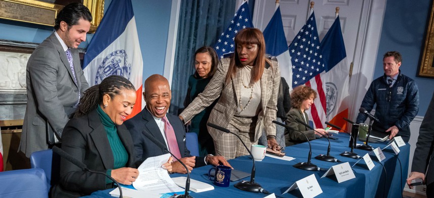 New York City Mayor Eric Adams, surrounded by, from left, Deputy Mayors Fabien Levy and Sheena Wright and, right, Senior Adviser Ingrid Lewis-Martin