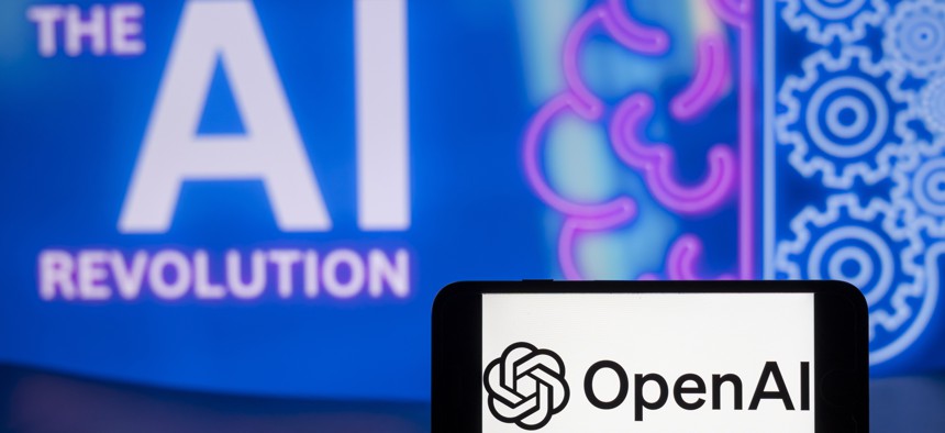 The logo of OpenAI is seen on a mobile phone screen with The AI Revolution symbol in the background.