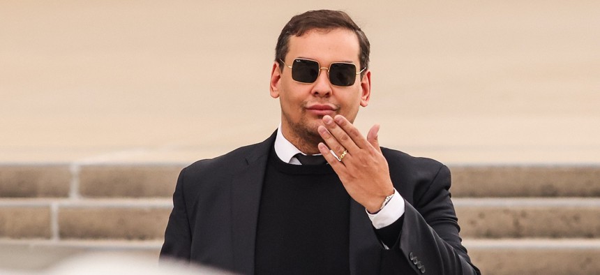 Rep. George Santos blows a kiss as he leaves the Alfonse M. D'Amato United States Federal court house after his appearance in Central Islip, New York on October 27, 2023. 