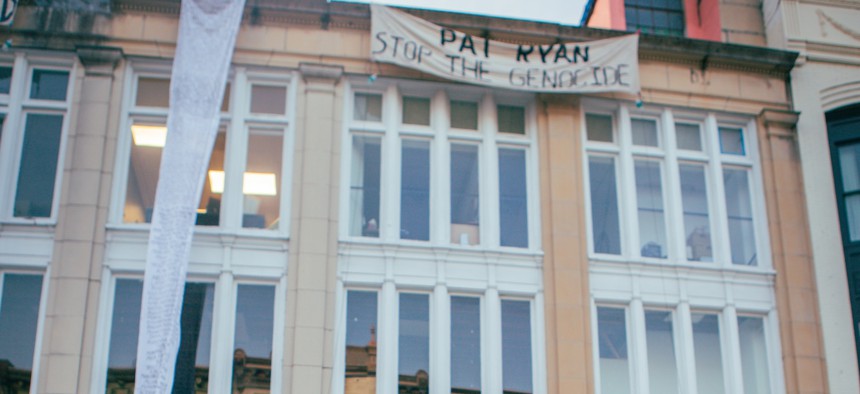 On Friday, protestors demonstrated outside Rep. Pat Ryan's district office in Kingston and hung a banner reading "Pat Ryan, Stop the Genocide" from the top of the building.