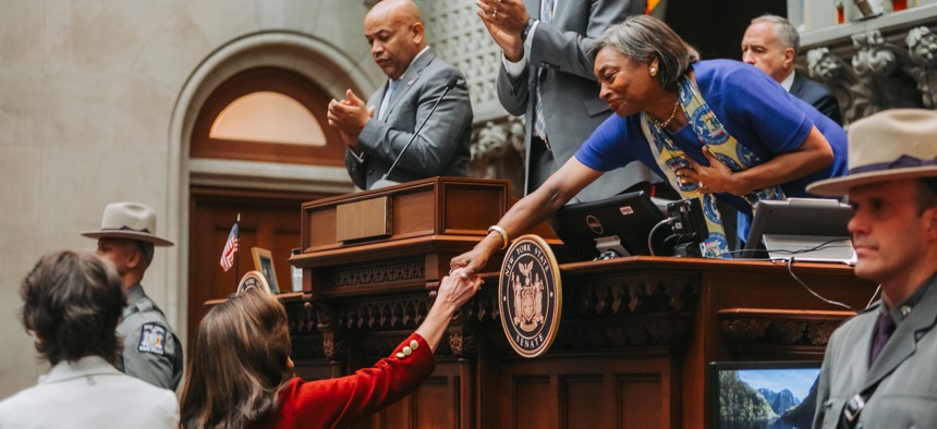 Gov Kathy Hochul, bottom left, shakes hands with state Senate Majority Leader Andrea Stewart-Cousins ahead of her State of the State address. Assembly Speaker Carl Heastie, left, and Lt. Gov. Antonio Delgado, center, look on.