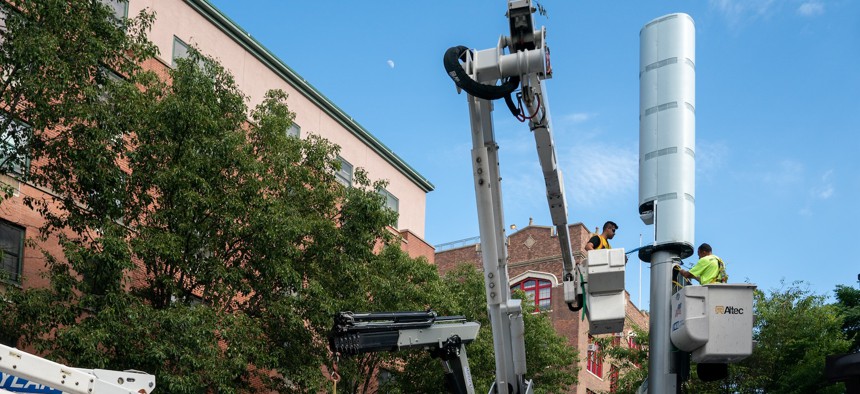 Workers install a Link5G pole in the Bronx.