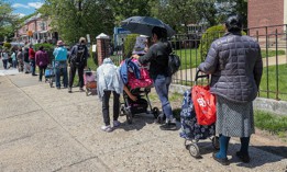People, facing food insecurity, wait in line to get meals served by the nonprofit Queens Together, representing local restaurants from the borough, on May 06, 2023. 