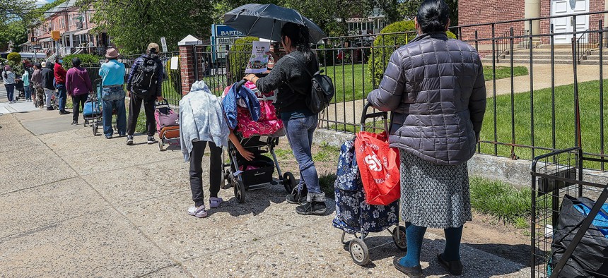 People, facing food insecurity, wait in line to get meals served by the nonprofit Queens Together, representing local restaurants from the borough, on May 06, 2023. 