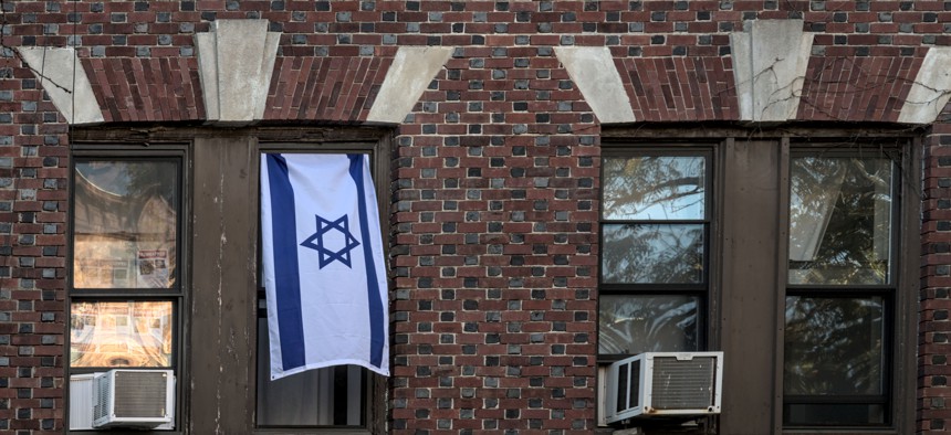 An Israeli flag hangs in the window of a Brooklyn apartment building