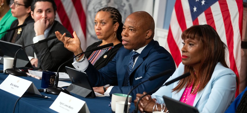 New York City Mayor Eric Adams, flanked by First Deputy Mayor Sheena Wright (left) and chief adviser Ingrid Lewis-Martin (right), speaks at an off-topic press conference at City Hall on March 19, 2024.