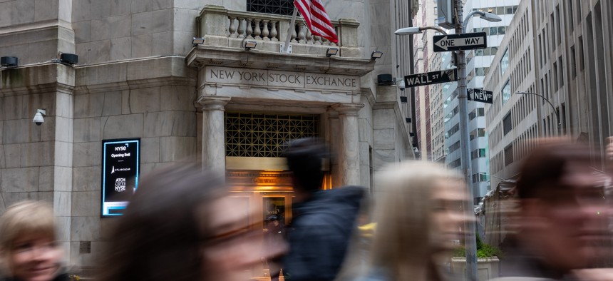 People walk outside the New York Stock Exchange on March 6, 2024.