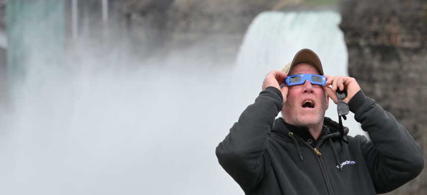 A man views the total solar eclipse at Niagara Falls State Park on April 8.