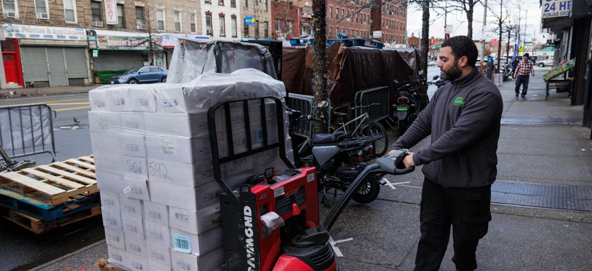 A City Harvest worker delivers 10 pallets of dried dates and rice flour to the Council of Peoples Organization in Coney Island