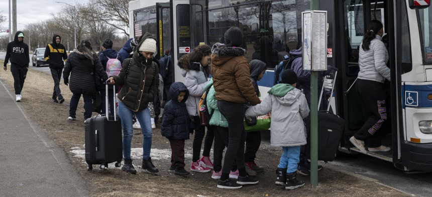 Migrants get on a bus outside Floyd Bennett Field in Brooklyn.